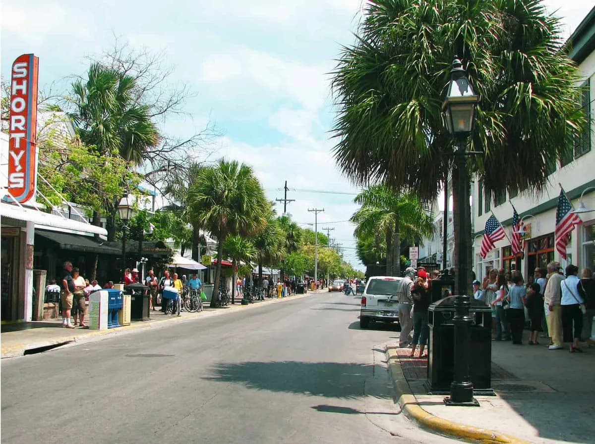 Shorty's in Key West: the tall red-and-white Shorty's sign over the storefront on a sunny street lined with palm trees.